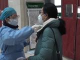 Small a nurse measuring the body temperature for outpatients in hubei tcm hospital
